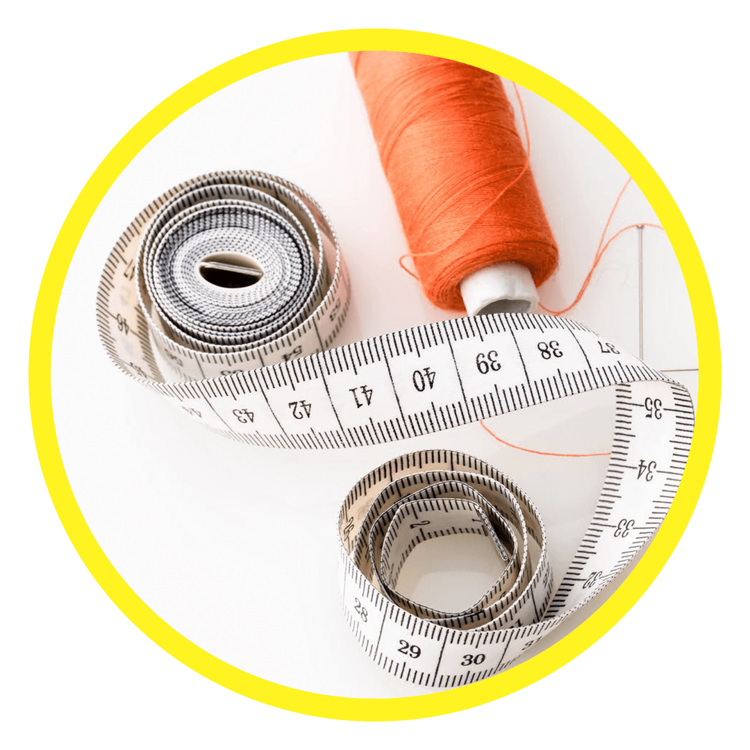 an orange thread reel and a measuring tape